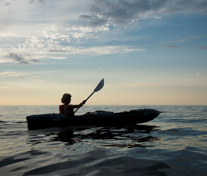 A person kayaking on the sea