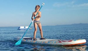 A toddler on a standup paddleboard in Croatia