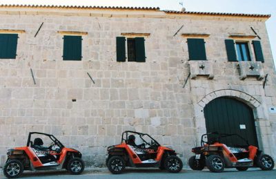 Buggies parked in front of an old building in Zadar