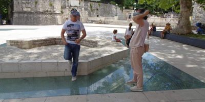 Tourist looking through VR goggles at Petar Zoranić Square in Zadar