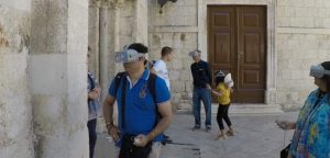 Tourist with VR glasses in front of Church of Chrysogonus in Zadar