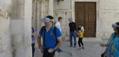 Tourist with VR glasses in front of Church of Chrysogonus in Zadar
