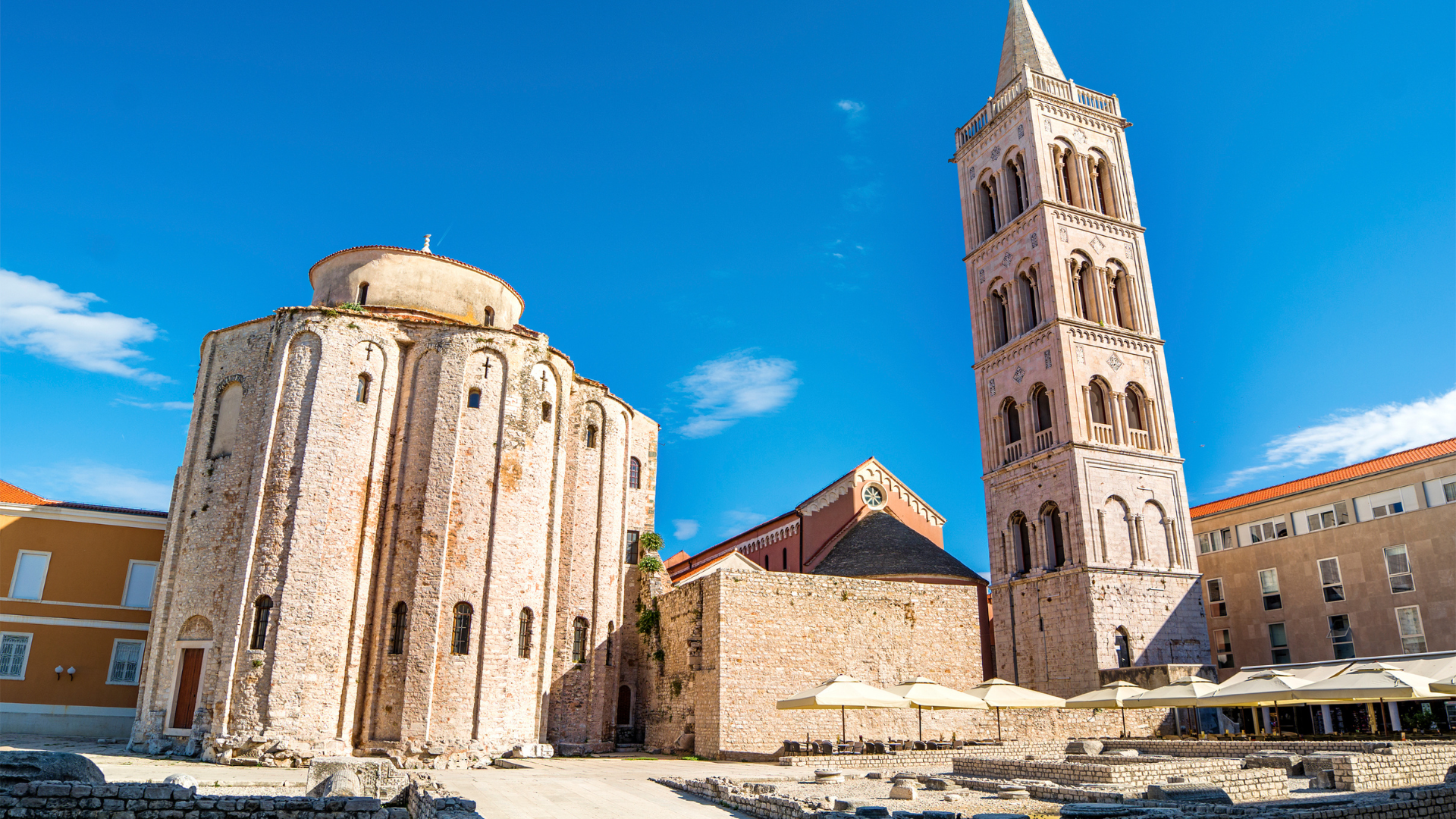 St. Donatus Church and St. Anastasia Cathedral bell tower in Zadar Old Town, Croatia, under a clear blue sky